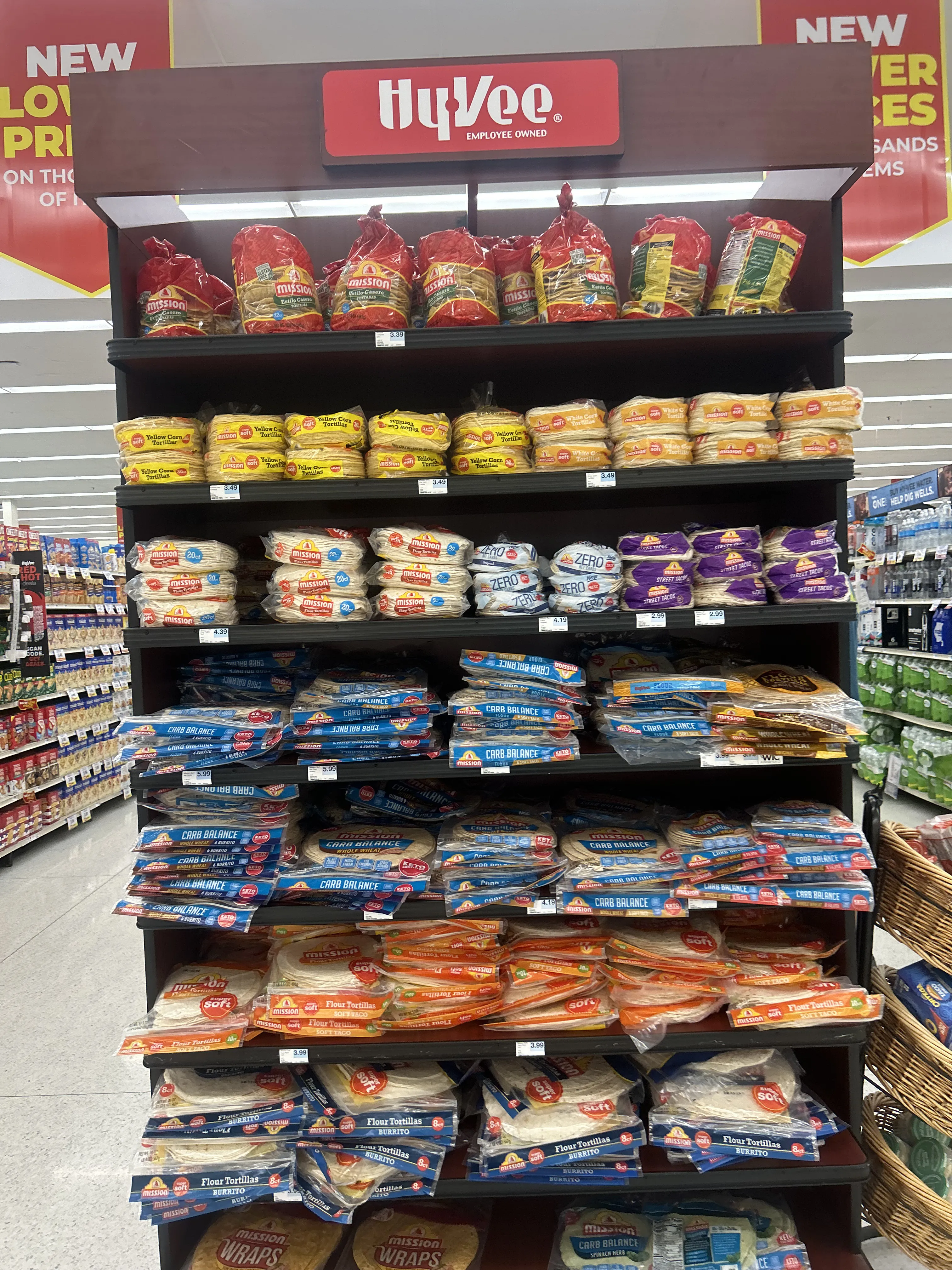 A fully stocked Mission tortilla shelf at a HyVee grocery store